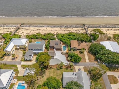 Aerial view of beachfront properties with pool and ocean