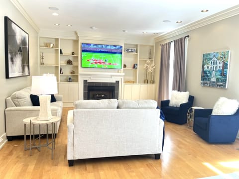Family Room with fireplace with streaming sunlight from the back patio