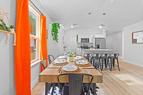 Spacious dining area that opens into a modern kitchen setup.