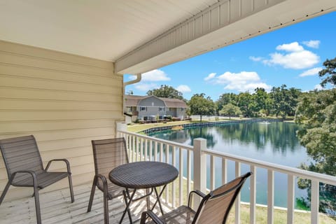 Private Balcony with Lake View – Second Floor - Second-floor balcony of Ocean Walk W-10 overlooking the peaceful lake, with seating for morning coffee and sunset drinks at this St. Simons vacation rental.