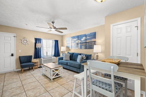 Cozy living area with a blue sofa and coastal-themed decor.