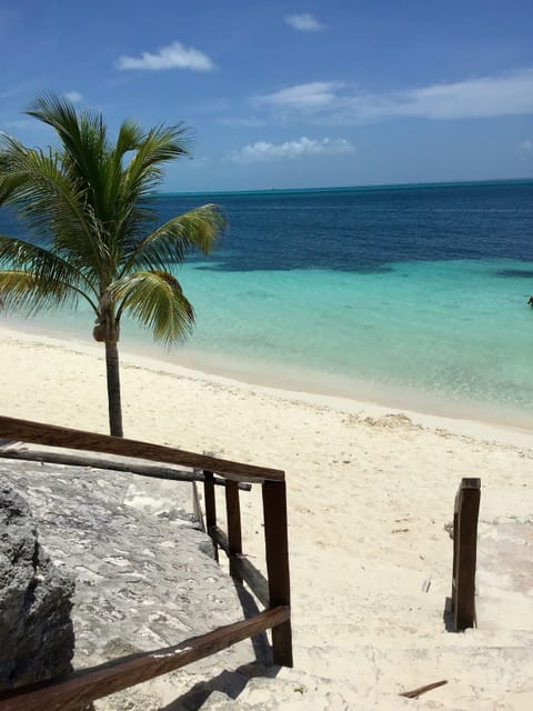 On the beach, white sand, sun loungers, beach umbrellas