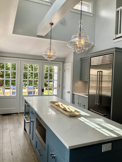 A large island with seating, refrigerator drawers, microwave drawer