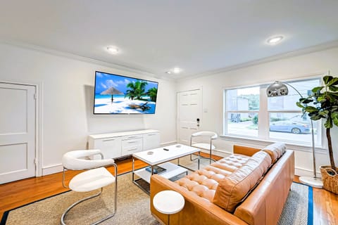 Living room complete with leather couch and 75" Roku TV. 