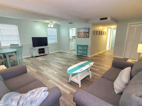Large living room with dining table, Large 50" TV. Hallway brings you to bathroom and bedroom. Closet on the right is packed with amenities including all your beach essentials, beach chairs, beach umbrellas, towels, cooler and much more!
