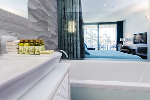 Separate tub and shower, rainfall showerhead, designer toiletries