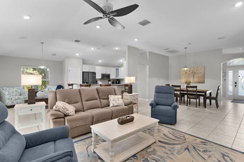 Relax in your spacious open-concept living area with plush seating, modern kitchen, and dining space—perfect for gathering with loved ones.