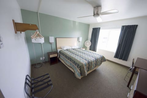 Bedroom interior with bed, lamp and hangers