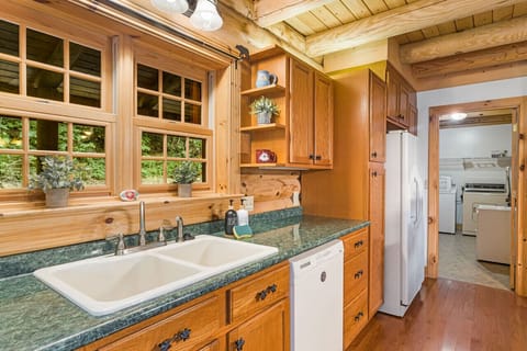 Lots of natural light will flood the kitchen during the day from the kitchen window. The laundry room is off the kitchen where you can find the high chair.