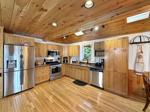 Kitchen: Wood accents meet modern appliances in this vibrant culinary space. Cook and create with ease!