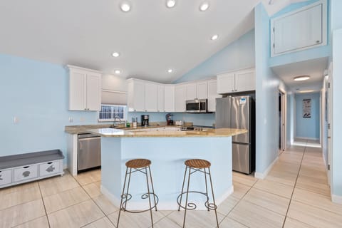 Gather around the kitchen island with stylish barstools, perfect for casual meals and conversation.