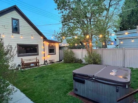 Backyard with hot tub, and string lights