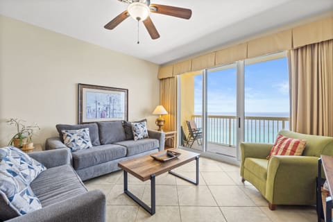 Living Room - Unwind in comfort in this open beachfront living area with a large flat-screen TV and floor-to-ceiling windows framing stunning sea views.