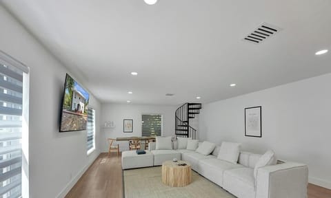 Living room includes massive sectional couch that rearranges for an additional sleeping area, in addition to a large 75" smart TV for all of your entertainment needs.