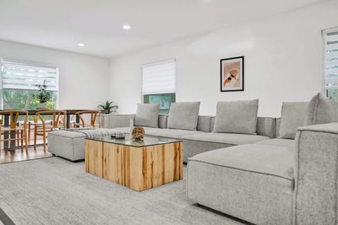 Living room includes massive sectional couch that rearranges for an additional sleeping area, in addition to a large 75" smart TV for all of your entertainment needs.