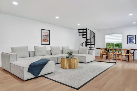 Living room includes massive sectional couch that rearranges for an additional sleeping area, in addition to a large 75" smart TV for all of your entertainment needs.