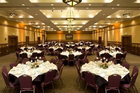 Elegant tables await your next special event, adorned with fine linens and delicate floral centerpieces.