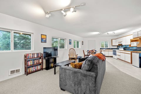 The primary living room features comfortable seating and a TV for your entertainment.