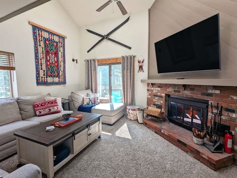 Our comfortable living room includes lots of natural light, a wood burning fire place, large television and seating for everyone.