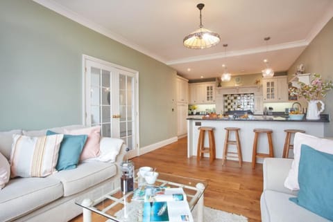 Tamarisk House, Newquay. Ground floor: Kitchen with a fabulous range cooker, breakfast bar, dishwasher, fridge/freezer and comfortable seating area