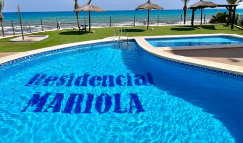 Our beachfront swimming pool offers you the perfect balance between relaxation and fun, with lawns and umbrellas to enjoy the sun and sea breeze.