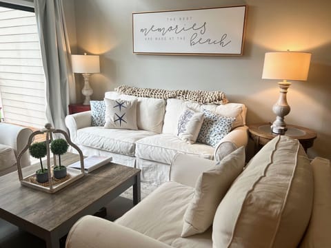 The inviting living room features comfortable and slipcovered seating.