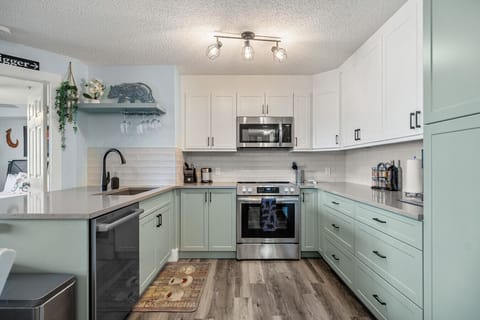 Fully redone kitchen with a drip coffee maker, ground coffee, tea, sugar, and basic condiments (ketchup, mustard, and relish.)
