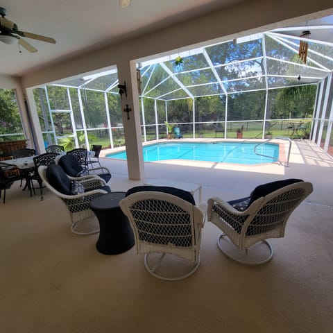 Lanai Patio Set with additional table and 6 chairs located by the outside bar