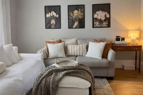 Cosy front room features two comfy 3 seat couches (1 sofa bed) and smart TV. 