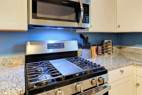gas stove and oven with ample spices and cooking supplies