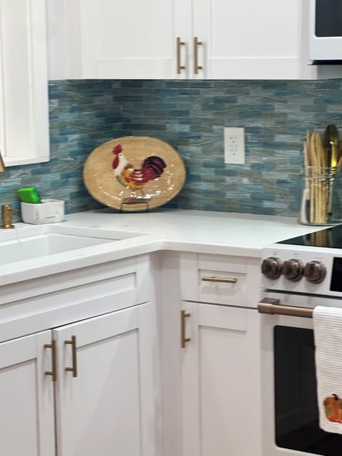 Kitchen boasts stainless steel pots/pans, silverware, dishes, and coffee makers.