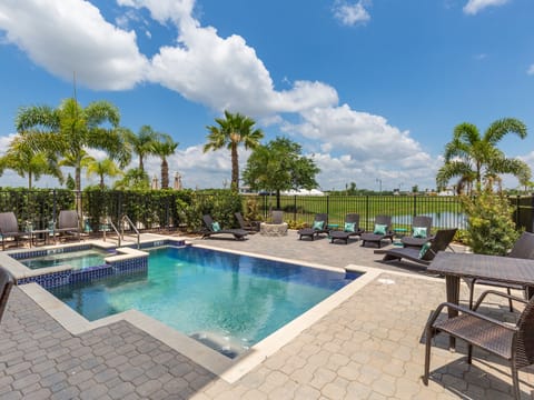 The pool area features multiple seating areas and 6 sun loungers