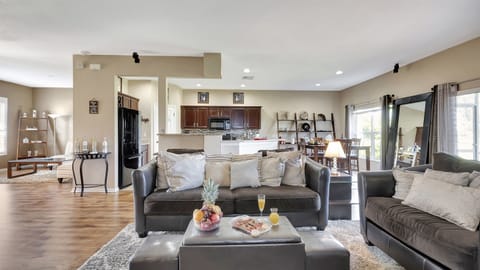 Our spacious living room beckons with a massive, plush grey sofa that practically envelops you in relaxation.