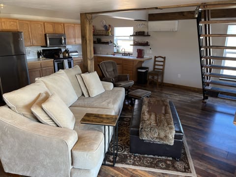 Oversized couch is cozy for end of day relaxing.