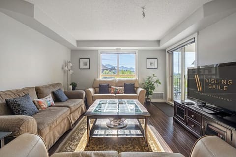 Living room with a Smart TV, cozy couches, board games and walkout access to the third-floor balcony.
