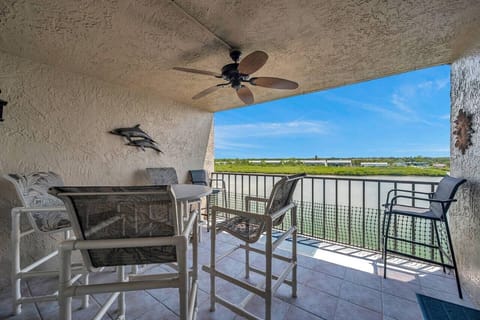 Covered balcony w/ seating, perfect for relaxing while enjoying fresh air & open views.