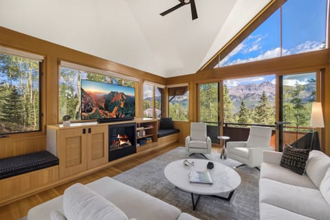 A beautifully designed living room features a sleek electric fireplace, cozy seating, and stunning décor that creates a warm, inviting atmosphere.