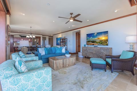 Sink into plush coastal-inspired seating and let the ocean breeze from your ceiling fan wash over you in this spacious, light-filled retreat.