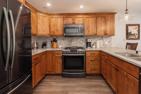 Your fully equipped kitchen features warm wood cabinets, granite counters, and stainless appliances—perfect for preparing memorable meals during your stay.