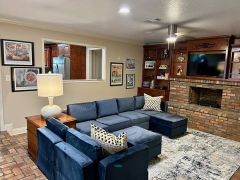 Open living room floor plan with 75" smart tv. Sofa converts to Queen size bed 