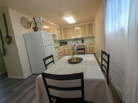 Fully equipped kitchen w/ organized storage & flow seamlessly to dining area.