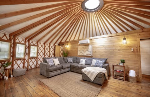 Such a cozy space with beautiful wood and natural light from the Yurt design.