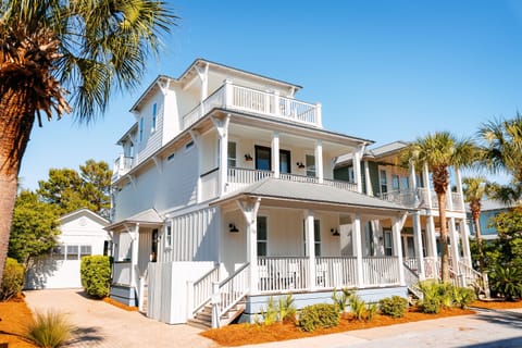Bright 3-story home with separate carriage house, multiple porches and walkable access to the beach, pool, green space, restaurants and shops.