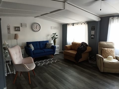 Living room, basic cable, Wi-Fi, ceiling fan, AC by dining room area.