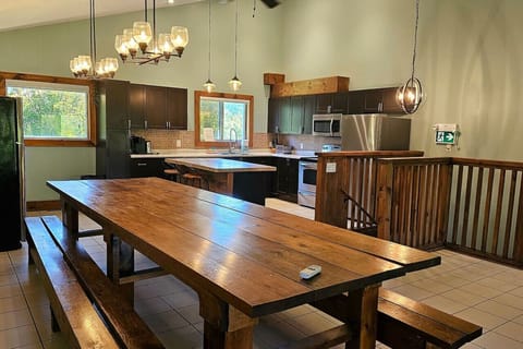Main dining area facing towards the kitchen and staircase on the upper level