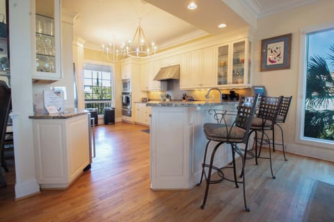 Your gourmet kitchen awaits with gleaming granite counters, premium appliances, and a breakfast bar perfect for morning coffee.