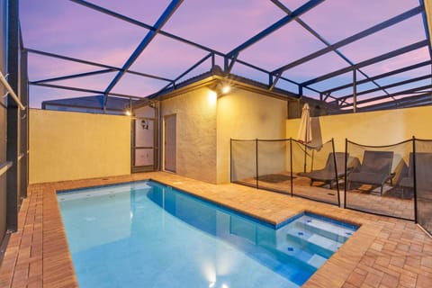 Private screened pool glows at dusk, inviting relaxed evening swims in a peaceful setting.