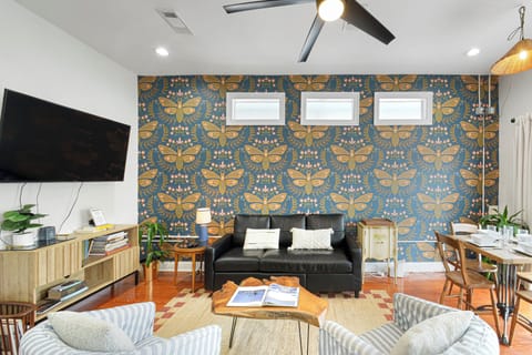 Living into Kitchen- seating for 10+, wall mounted smart TV w/ streaming service
