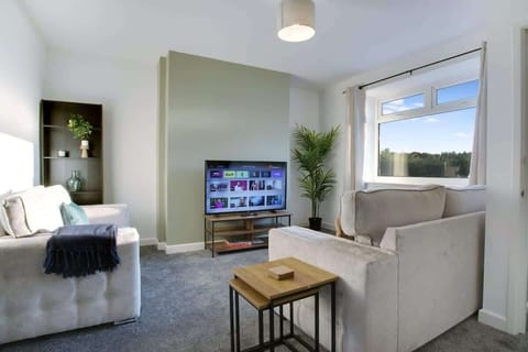 Cosy living room equipped with a  SMART TV with Netflix and a comfortable 2 sofas to sit down and relax. 