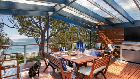 Latitude South Coast - vincentia pet friendly accommodation outdoor dining table with barbeque with beachfront views